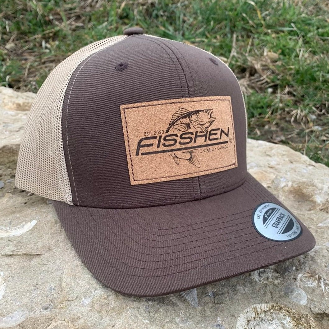 Fishing design with the word Fisshen. Trout image on a cork patch. Hat is brown with taupe back