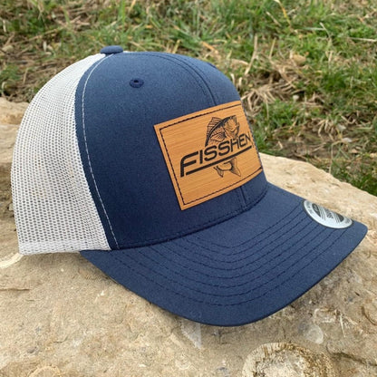Fishing design with the word Fisshen. Trout image on a bamboo patch. Hat is navy front and gray back